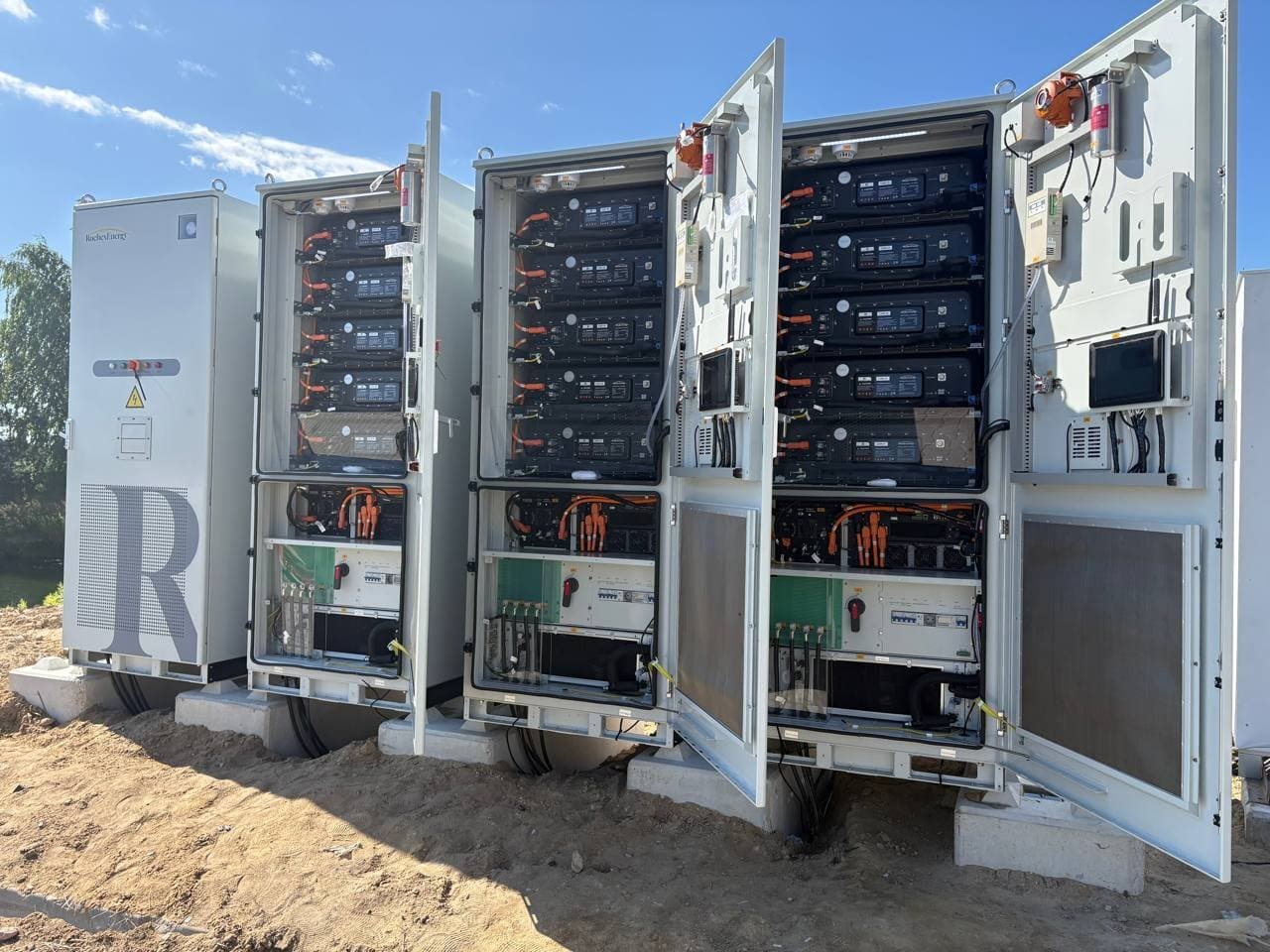 Four Roche Energy REL261 cabinets with doors open during commissioning